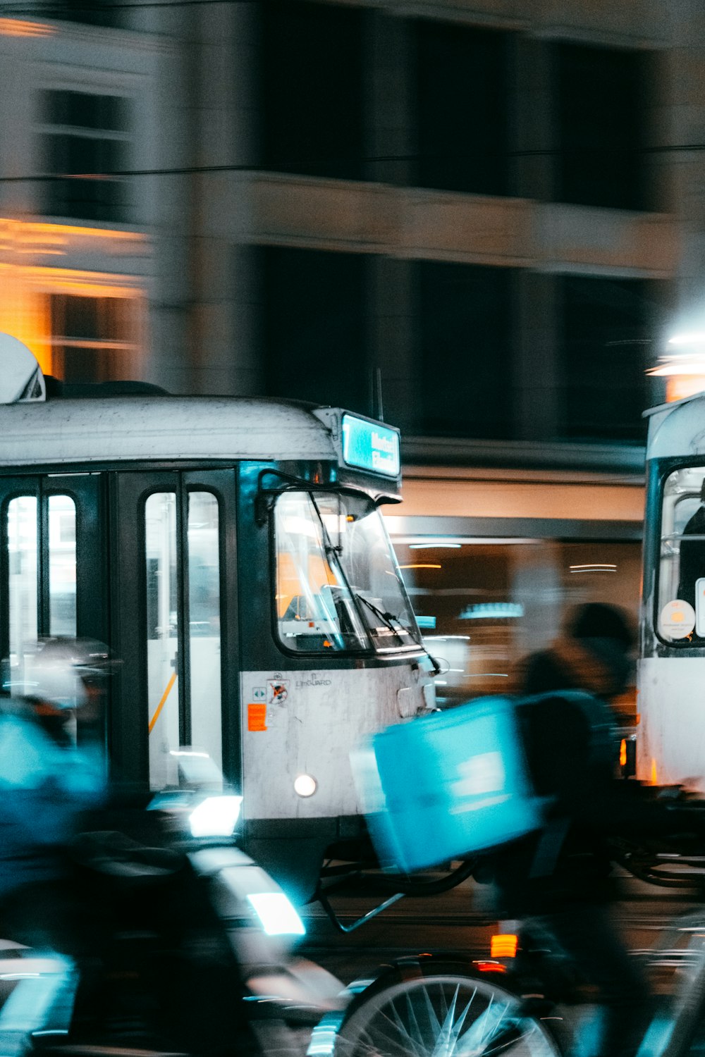 a group of people riding bikes next to a bus