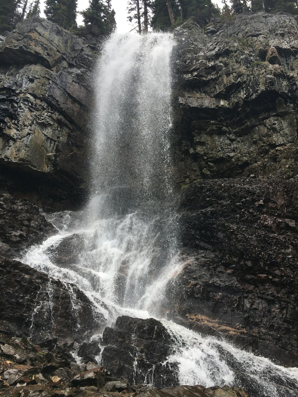 a large waterfall with water cascading down it's side