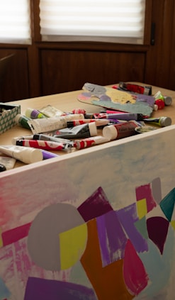 a table topped with lots of art supplies