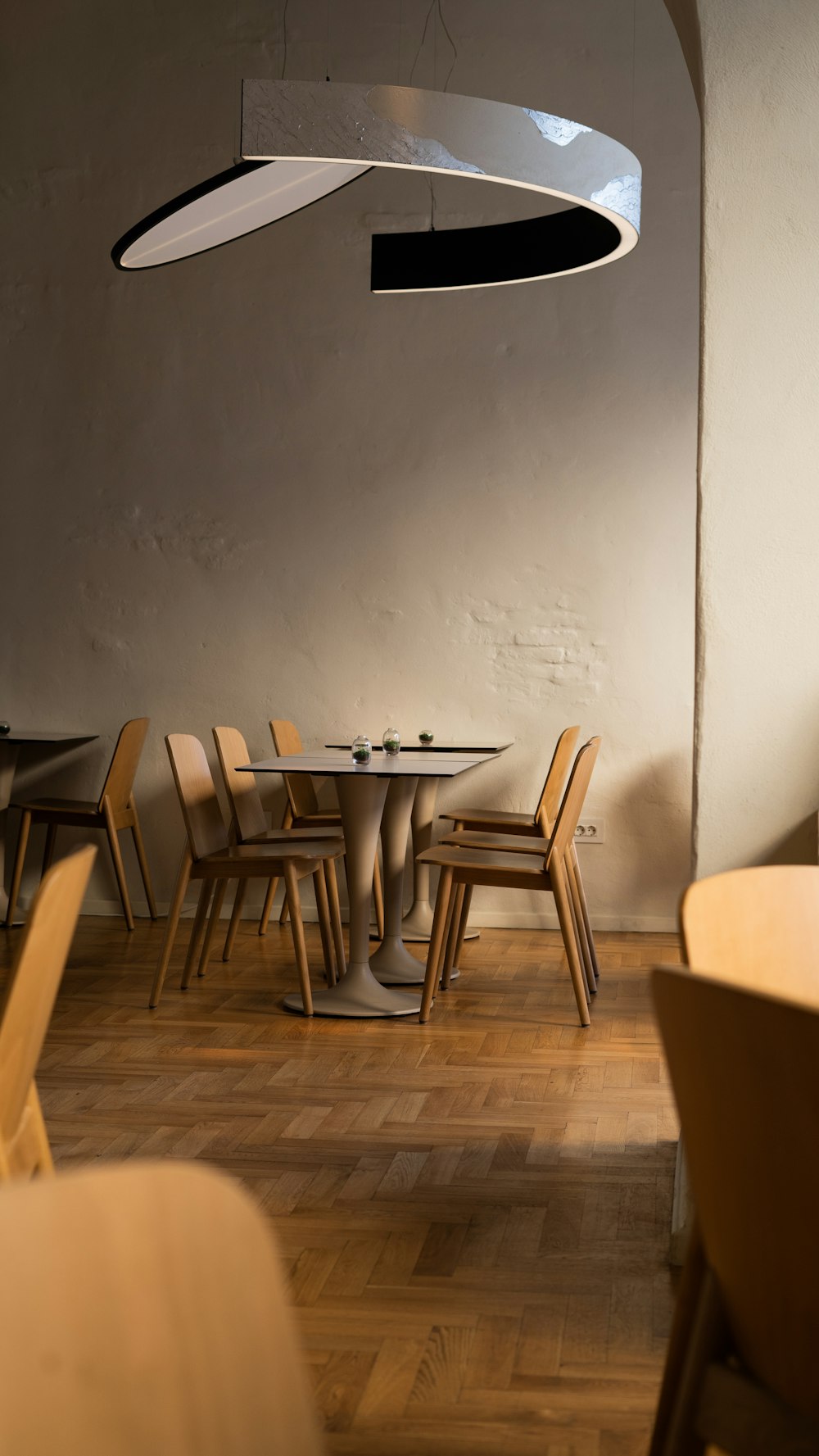 a dining room with a round table and chairs