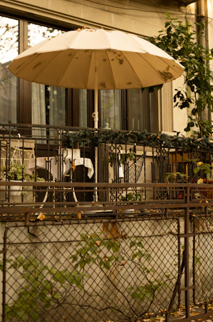 Weatherproof polyester balcony rug laid out on a sunny balcony with potted plants.
