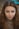 a woman with long brown hair and blue eyes