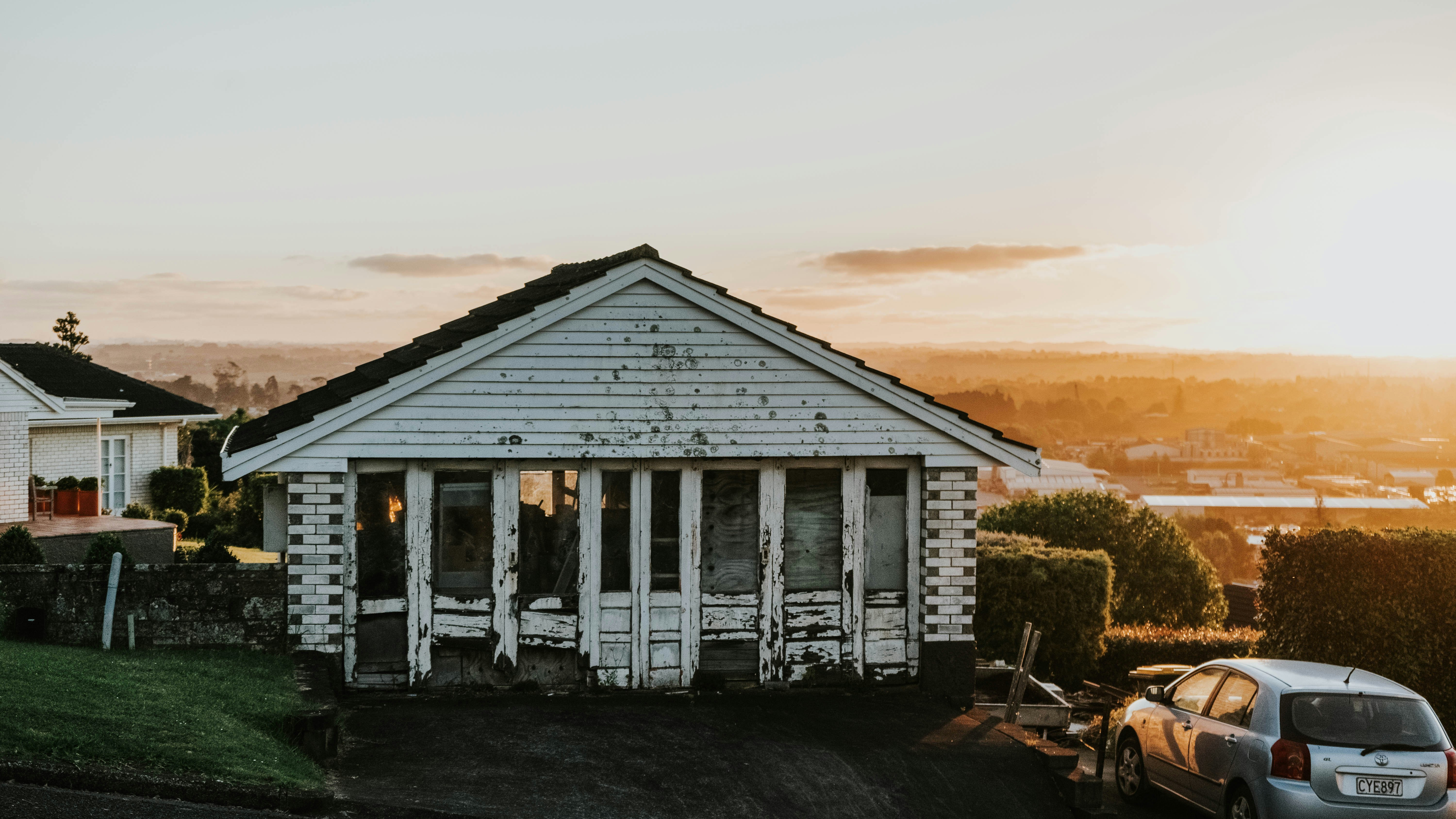 a white house with a car parked in front of it
