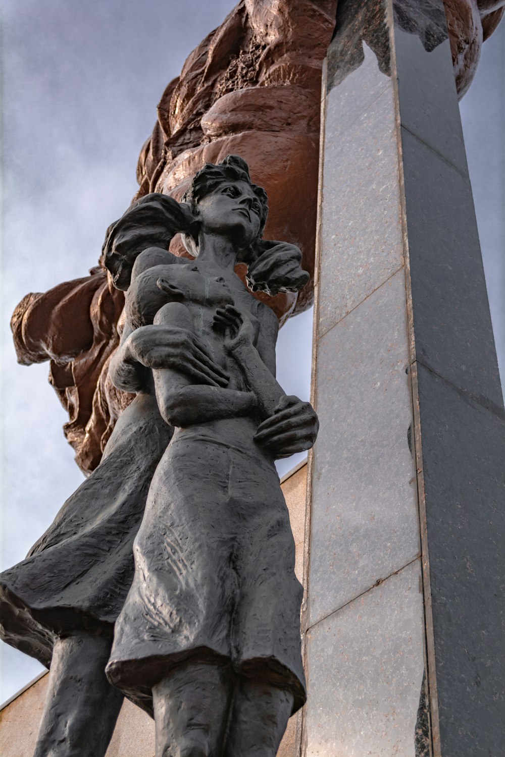 a statue of a man holding a woman in his arms