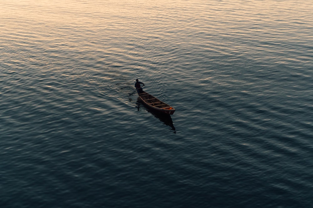 a person in a canoe paddling on the water