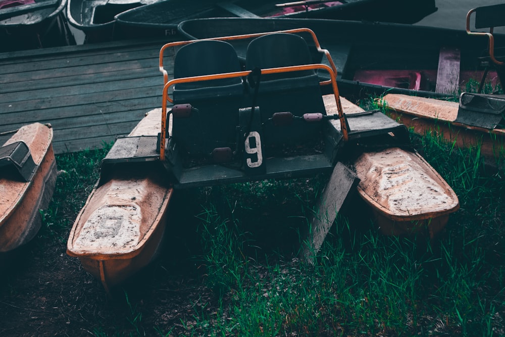 a row of wooden sleds sitting on top of a grass covered field