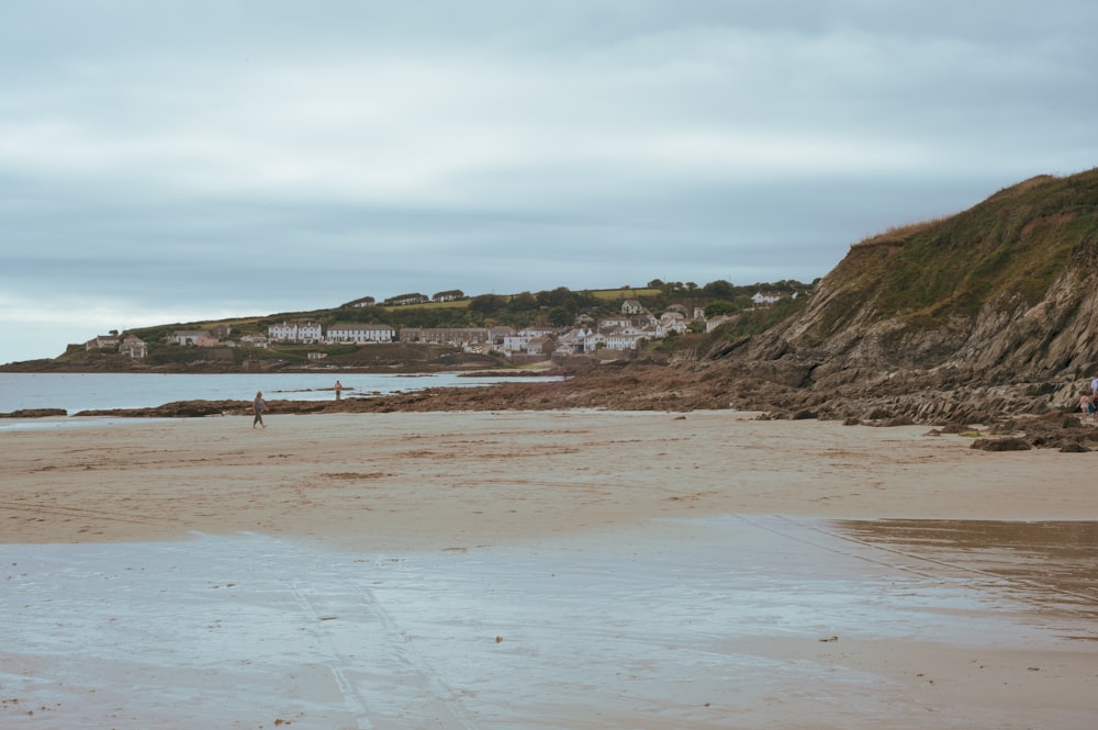 a person standing on a beach with a surfboard