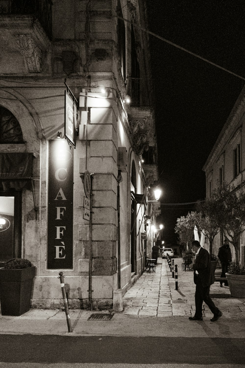 a man walking down a street at night