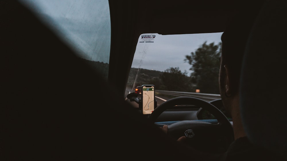 a person driving a car on a highway