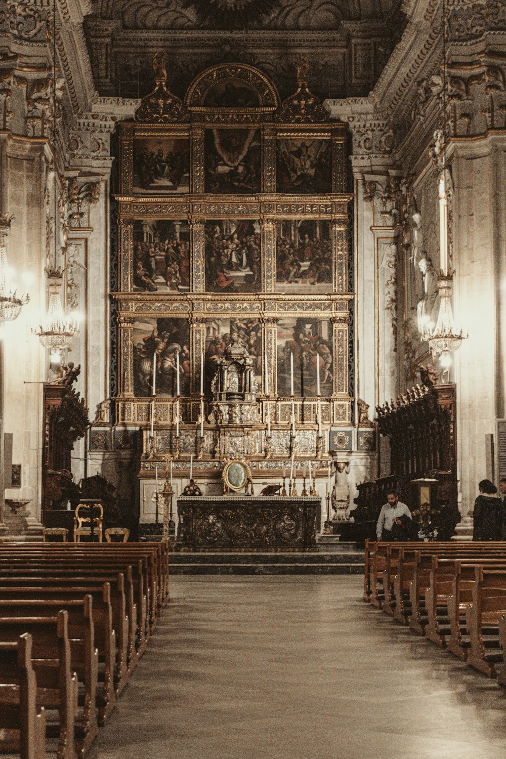 the interior of a church with pews and paintings on the wall