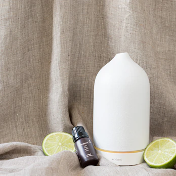 Smooth aroma diffuser stones resting on a light linen cloth with subtle shadows.
