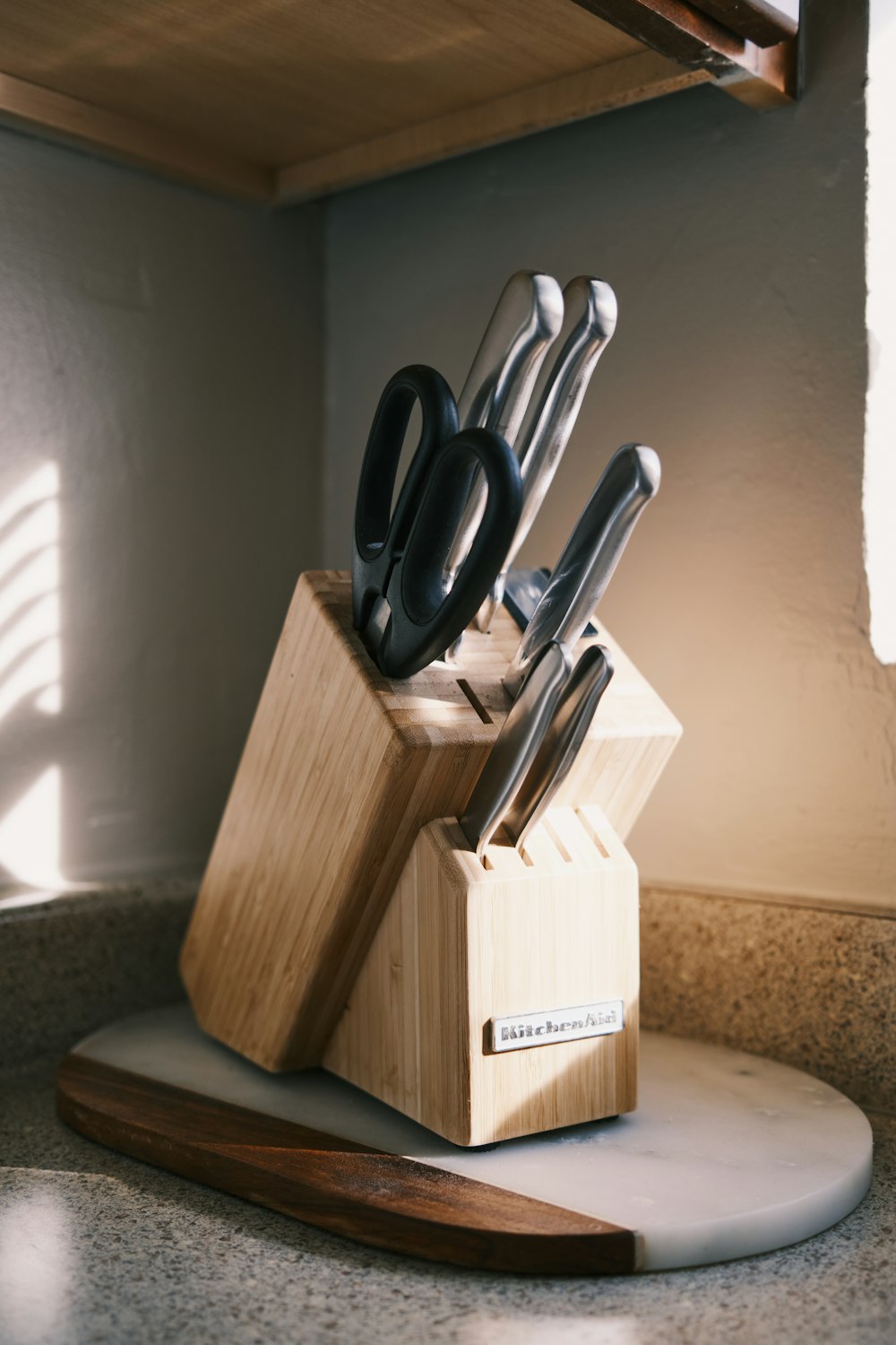 a wooden block with a knife holder holding knives