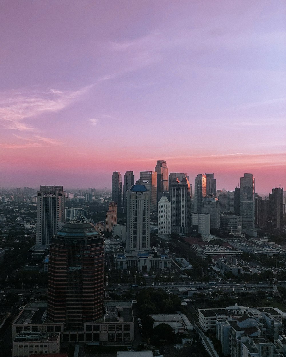 a view of a city at sunset from the top of a building