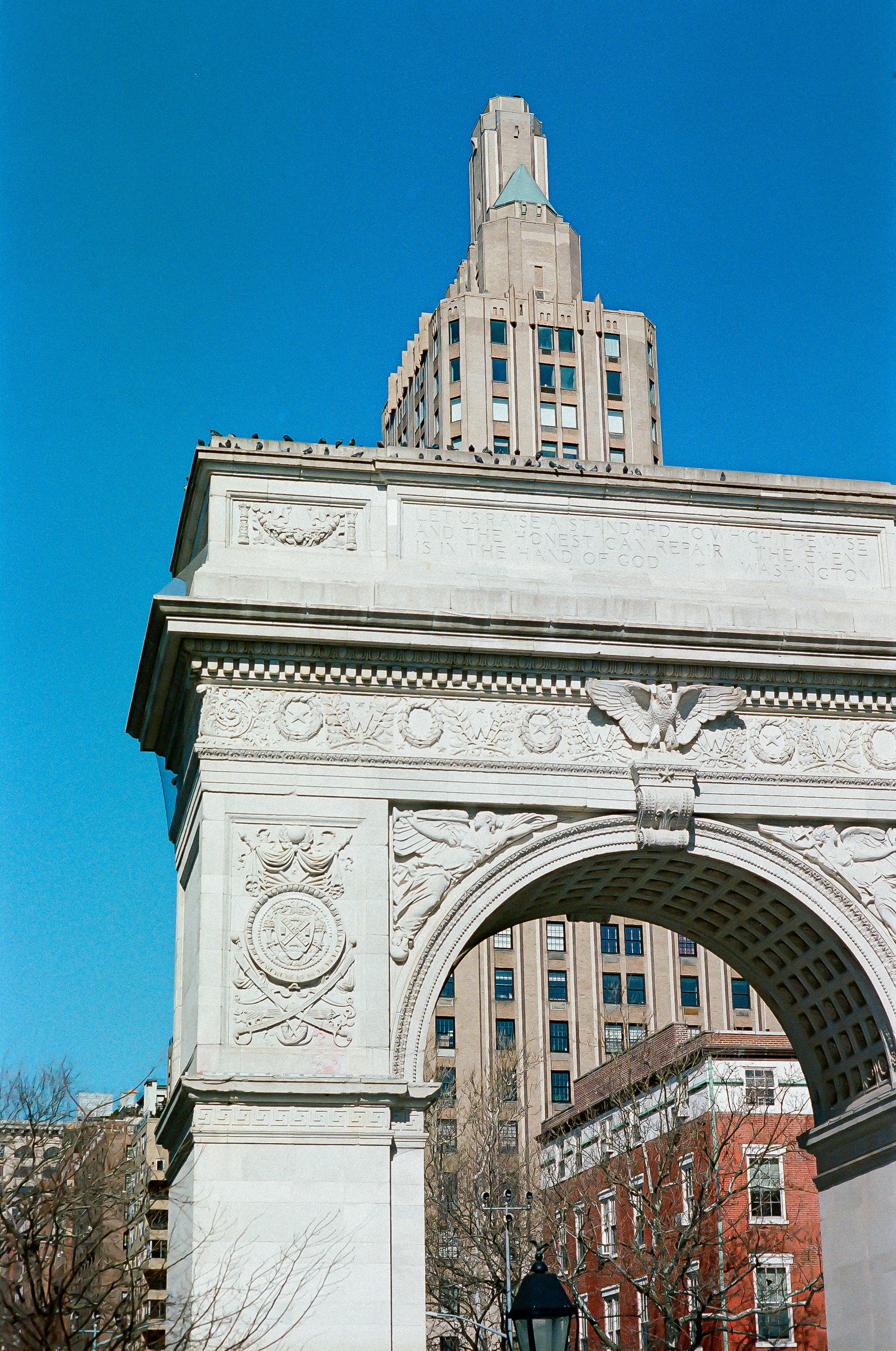 A large white arch with a clock on top of it