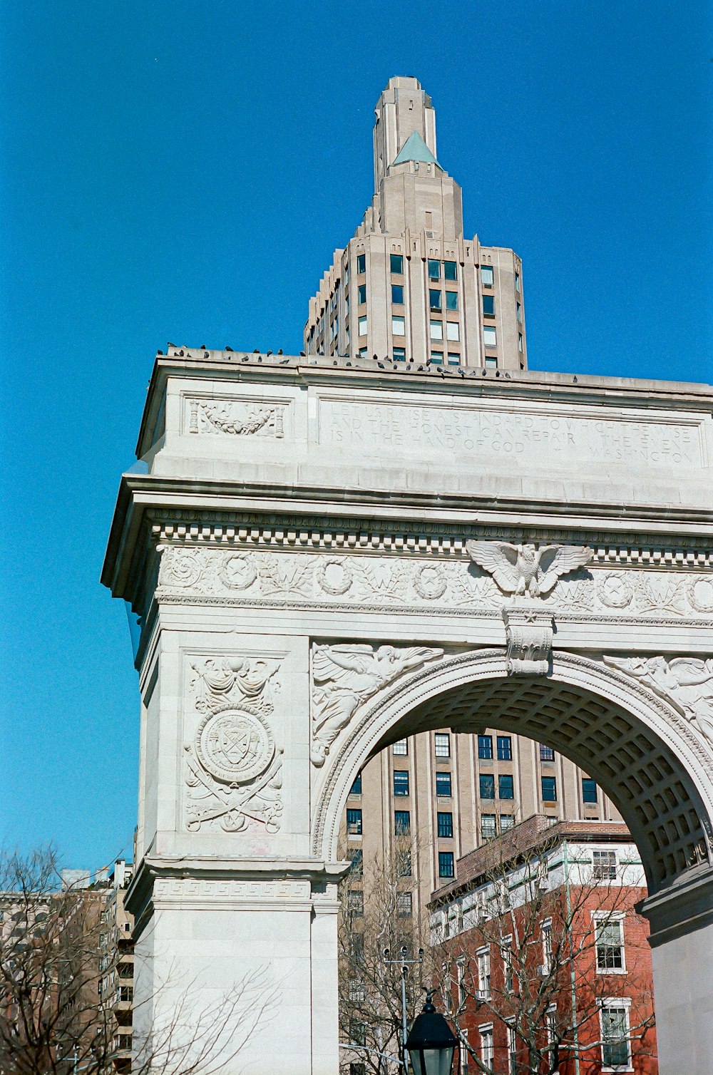 a large white arch with a clock on top of it