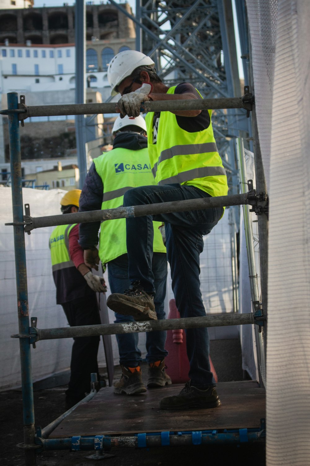 a group of men standing on top of a metal structure