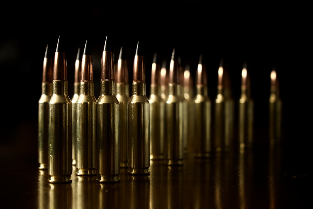 a bunch of bullet shells lined up on a table
