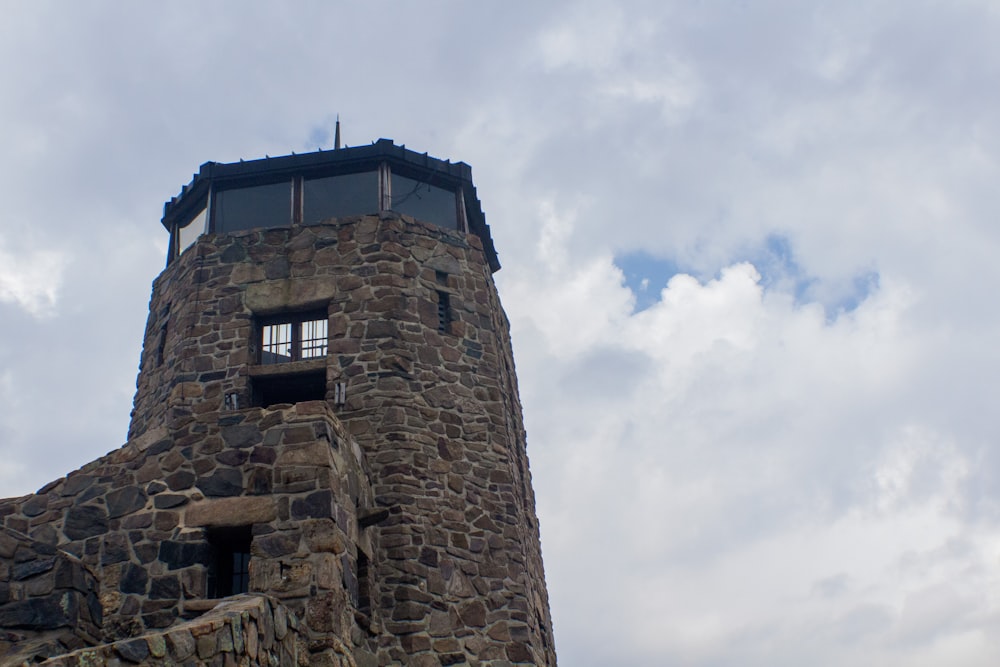 a tall stone tower with a sky background