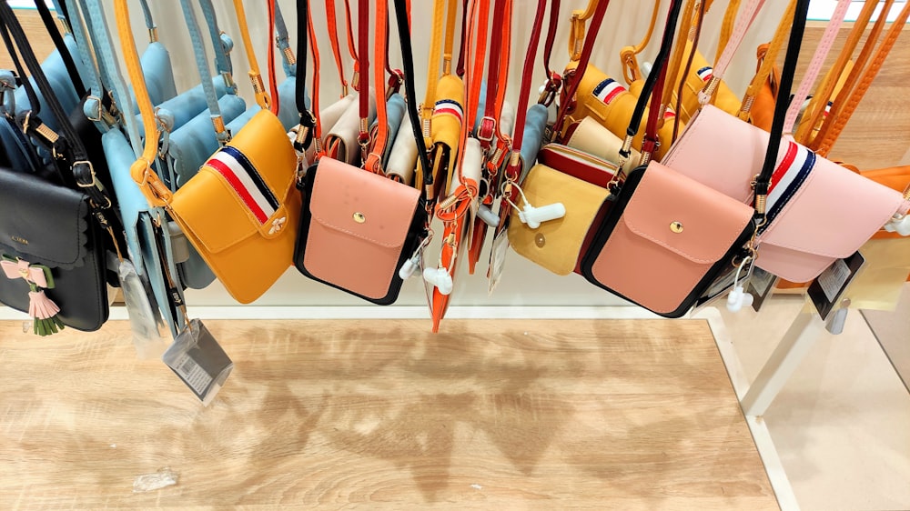 a bunch of purses hanging on a wall