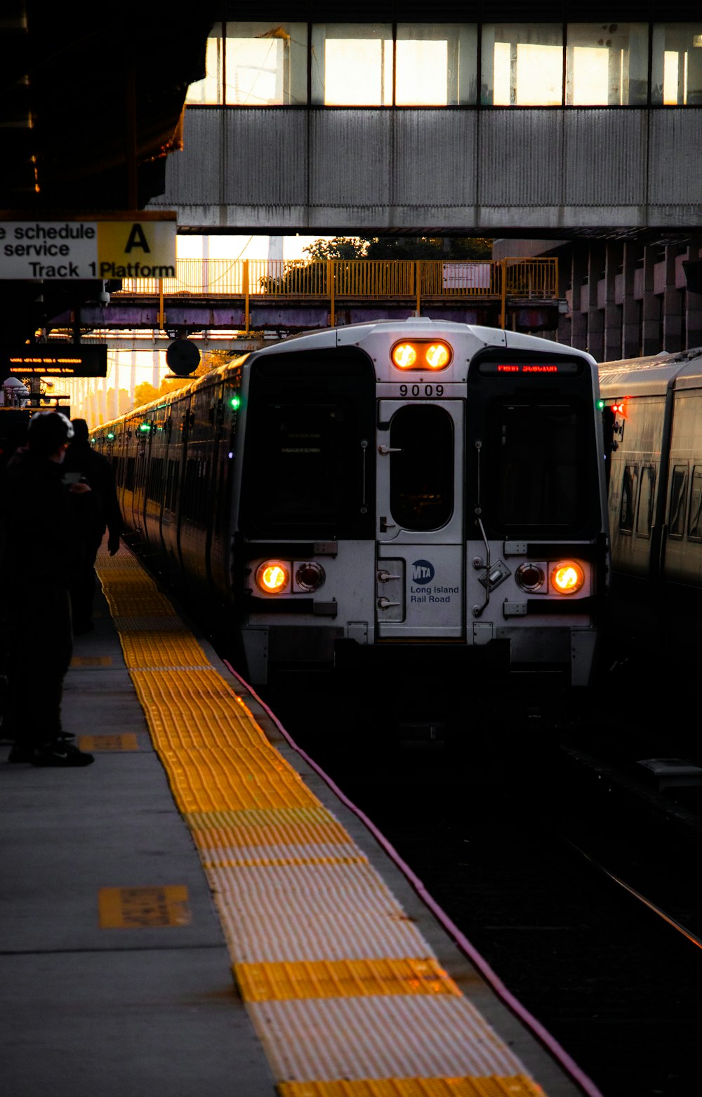 a train pulling into a train station next to a platform