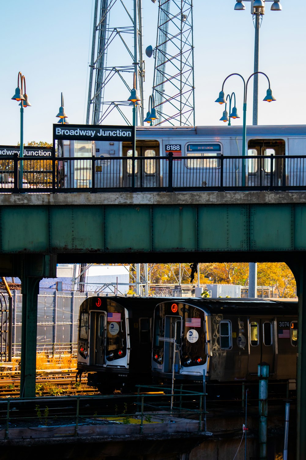 a train traveling over a bridge next to a train station