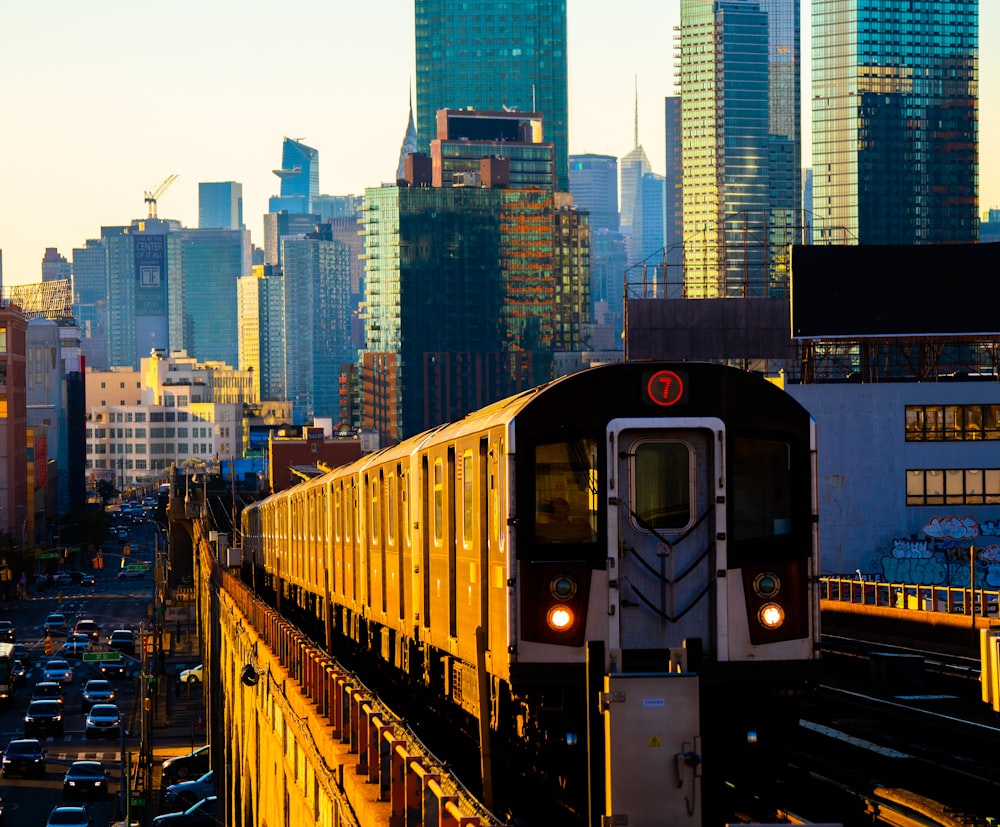 a train traveling through a city with tall buildings