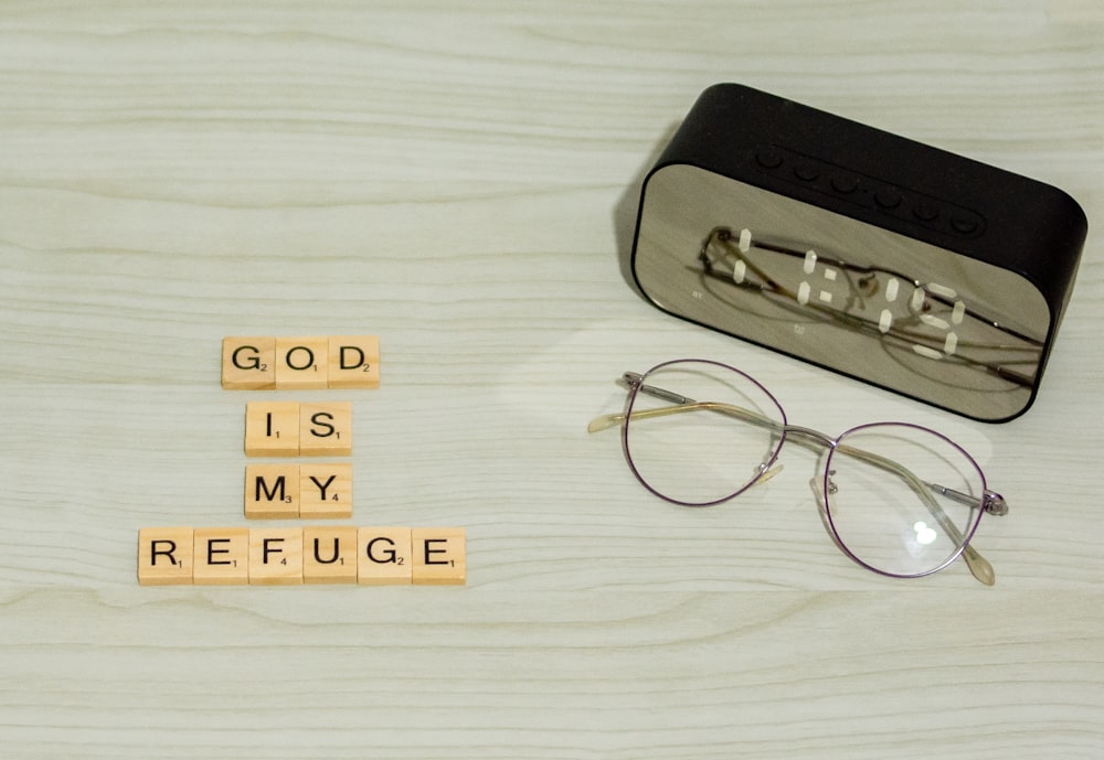 a pair of glasses sitting on top of a wooden block