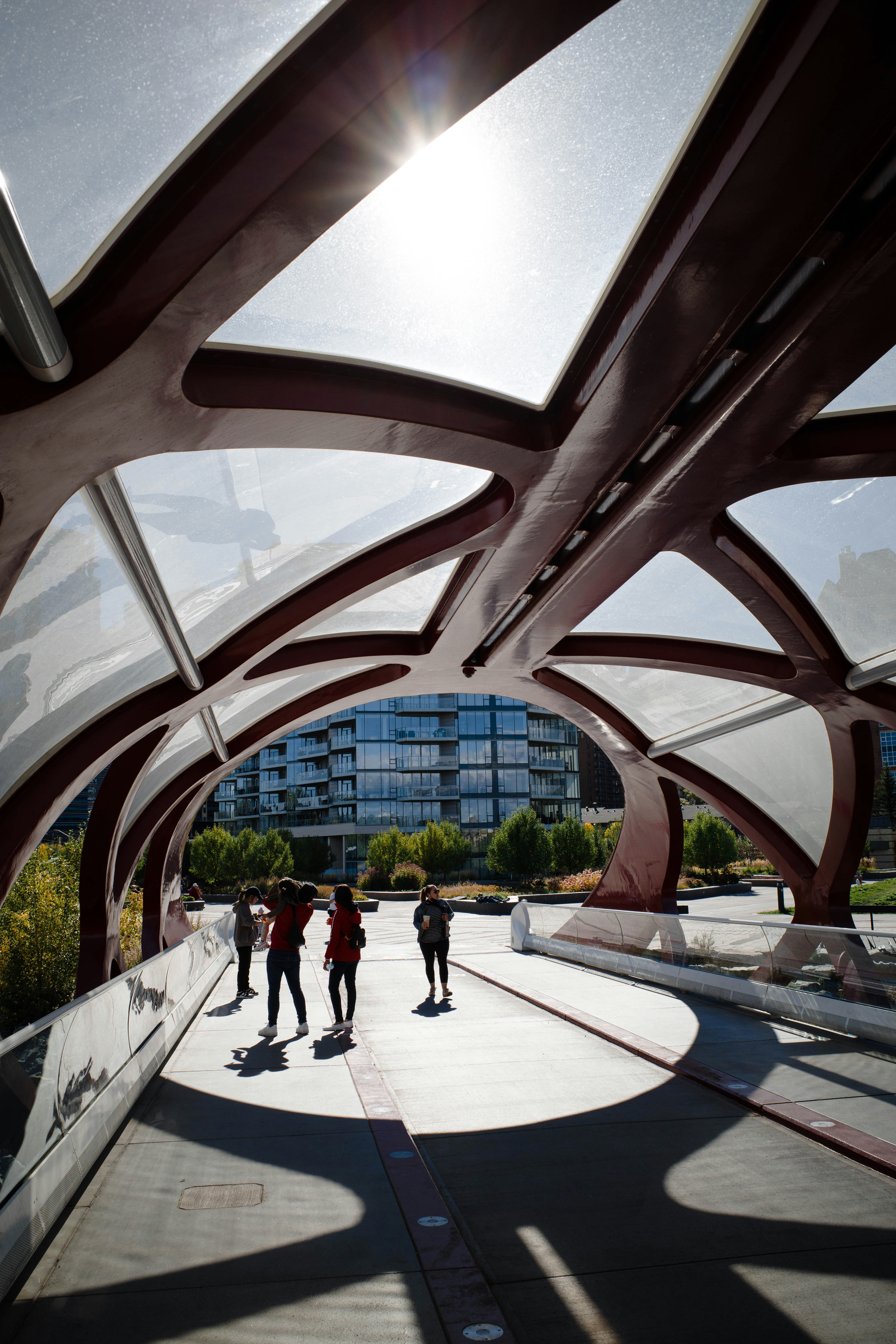 A group of people walking across a bridge photo – Free Grey Image on ...