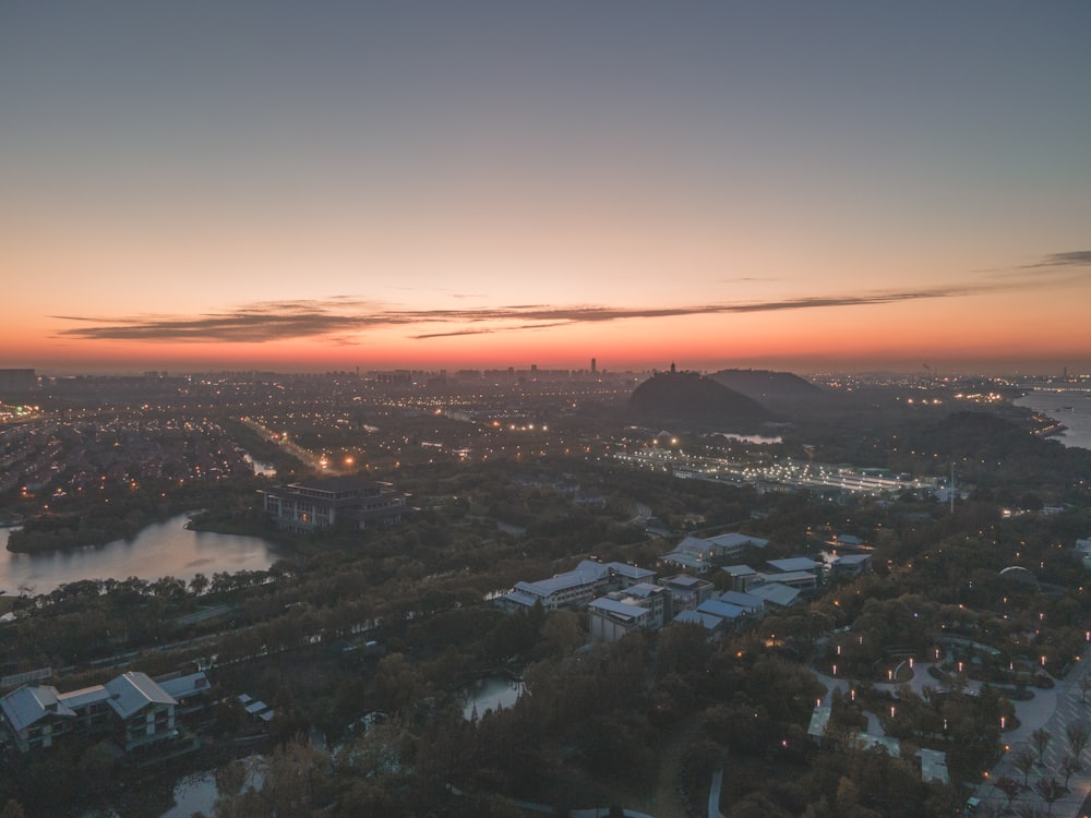 a view of a city and a lake at sunset