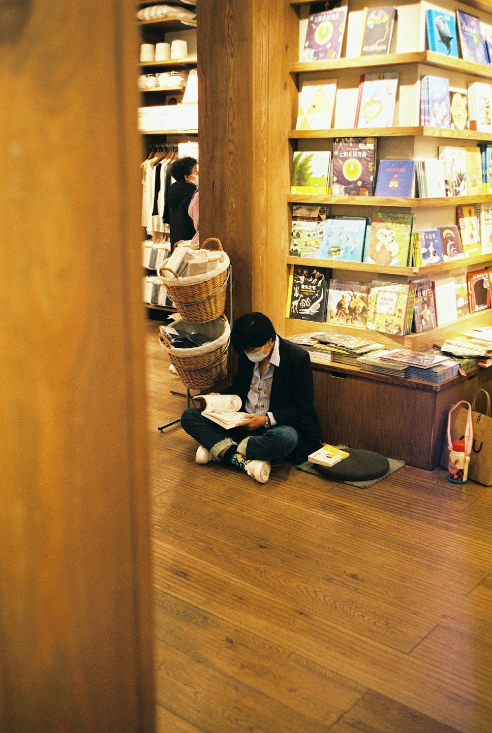 a woman sitting on the floor reading a book