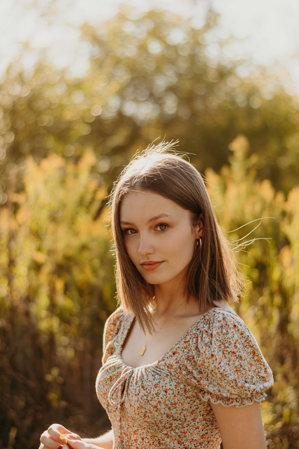 a woman standing in a field of tall grass