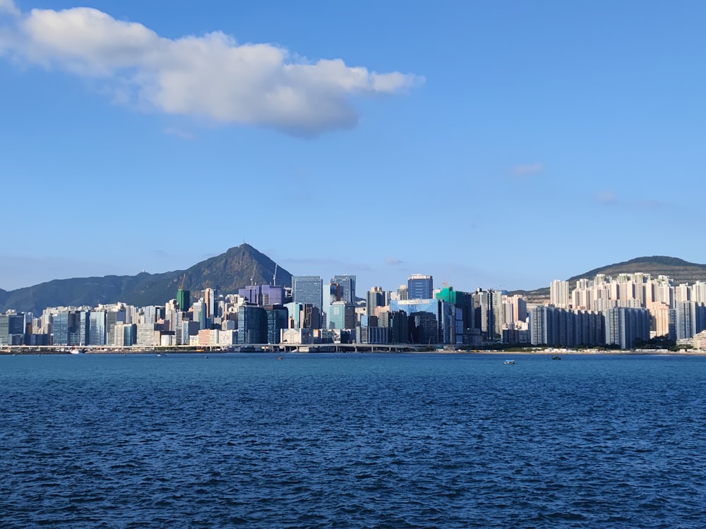 a large body of water with a city in the background