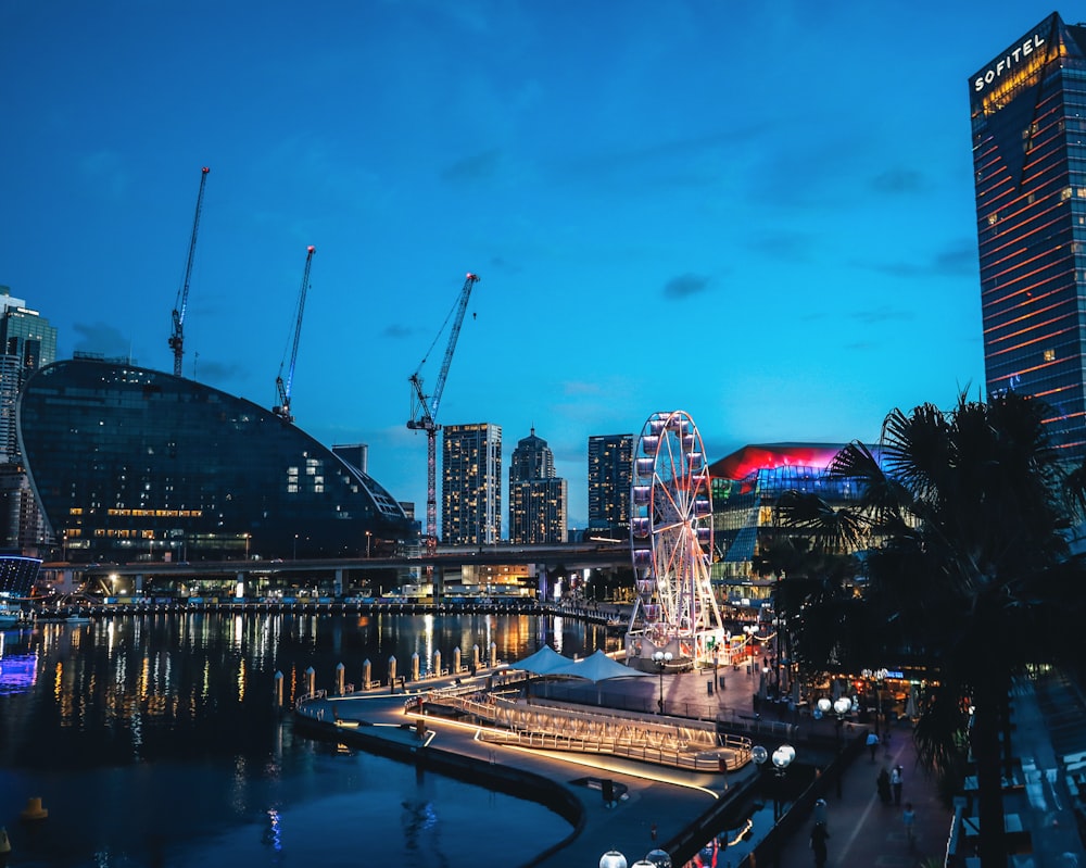 a large ferris wheel sitting next to a river