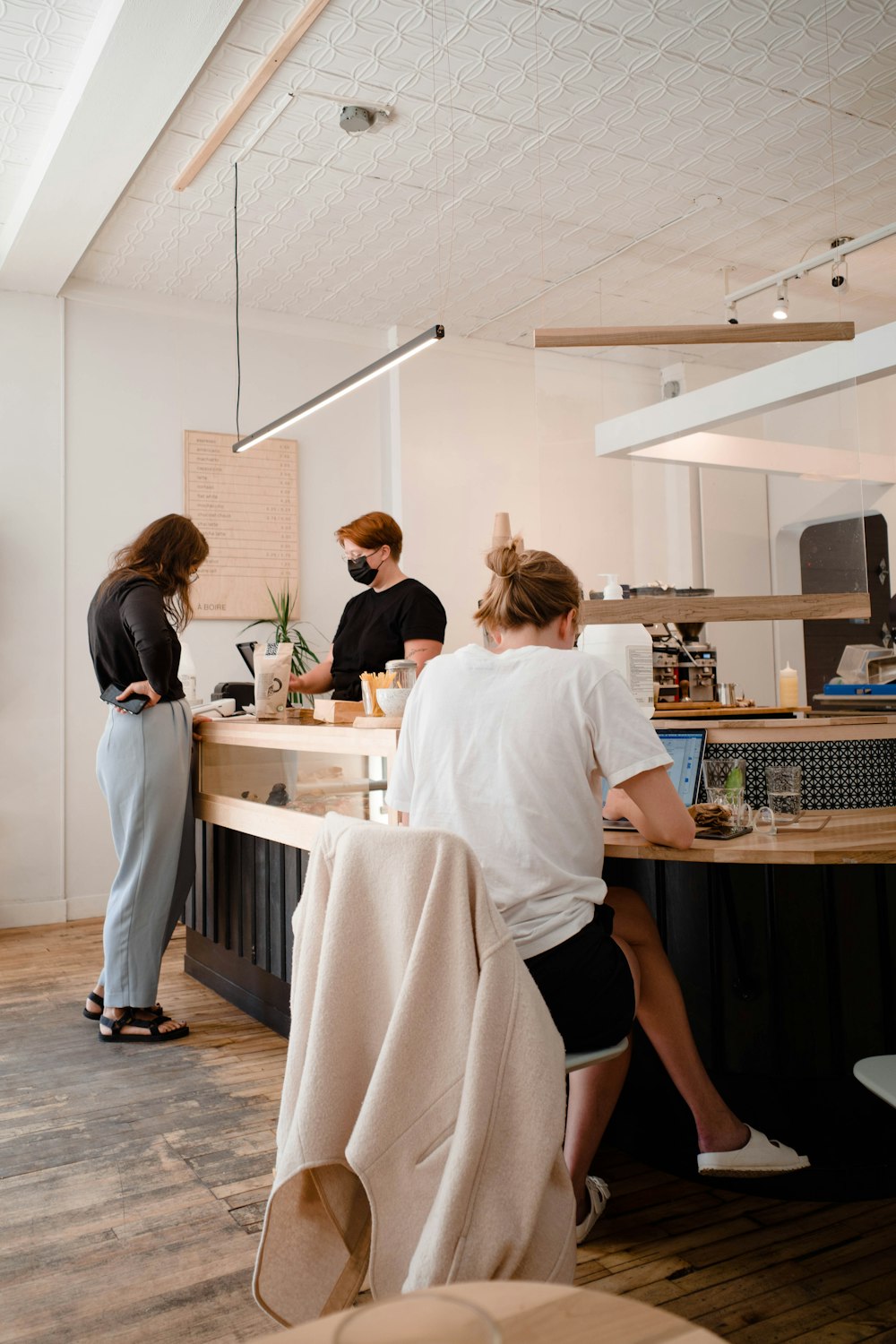 a group of people standing around a kitchen counter