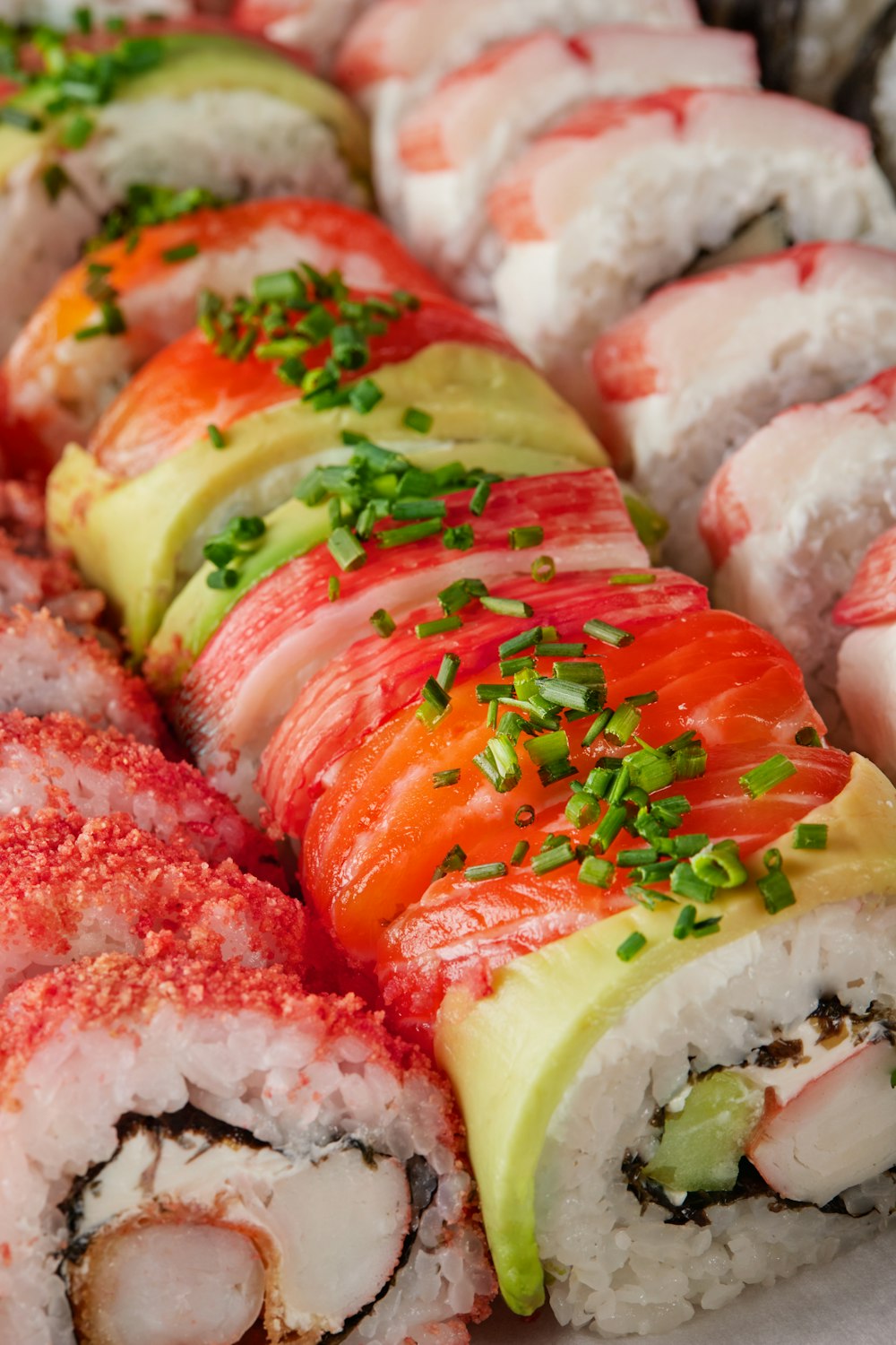 a platter of sushi with various toppings