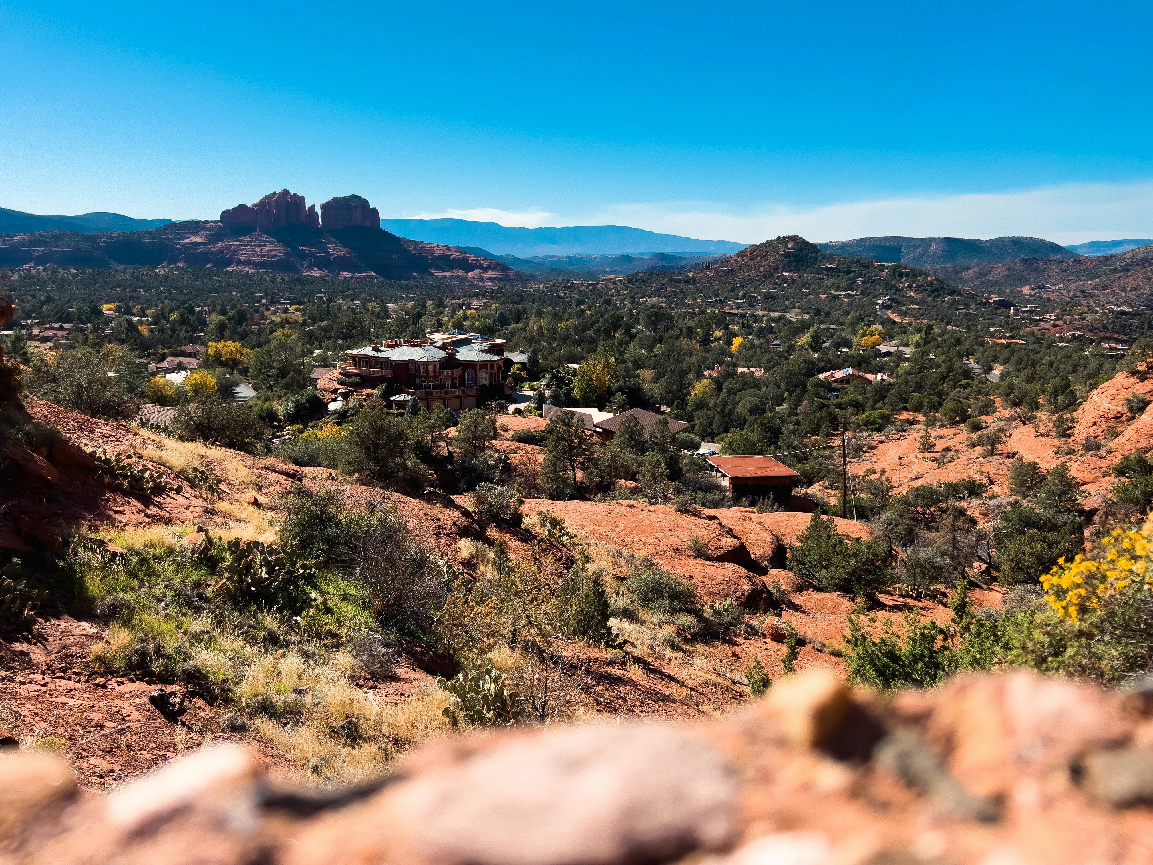 a scenic view of a small town in the mountains
