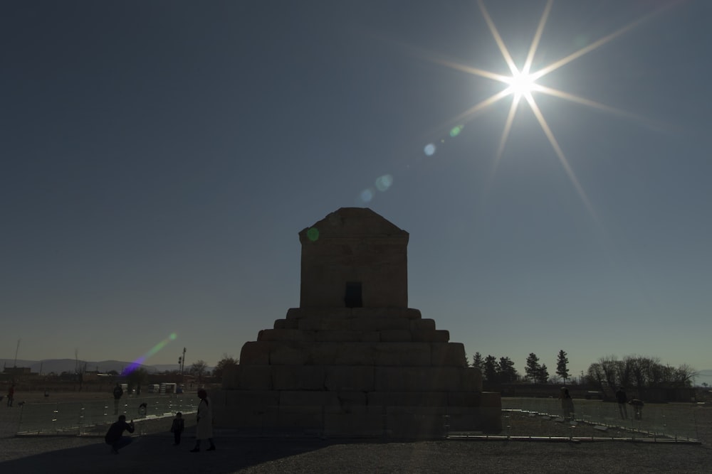 the sun shines brightly over a monument