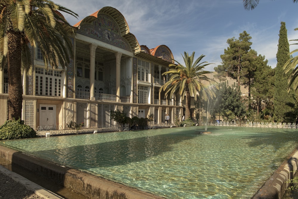 a large building with a fountain in front of it