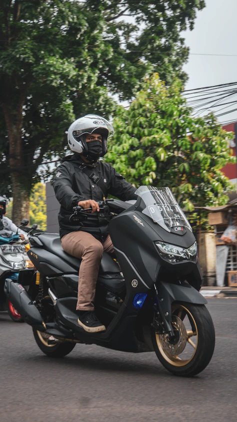 a man riding a motorcycle down a street