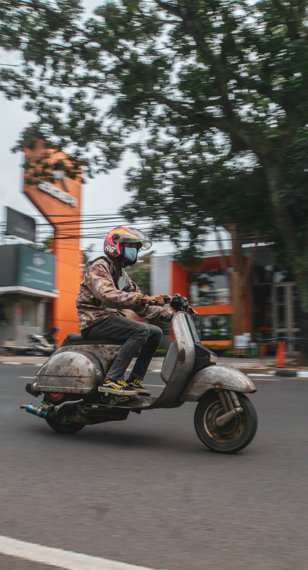 a man riding a motorcycle down a street