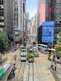 a street filled with lots of traffic next to tall buildings