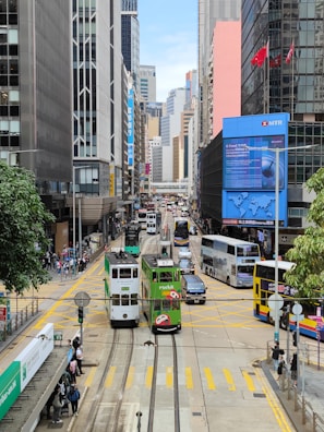 a street filled with lots of traffic next to tall buildings