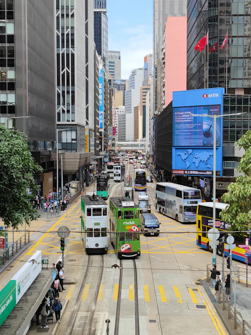 Double-decker trams and weekday traffic on Des Voeux Road Central, Hong Kong Island