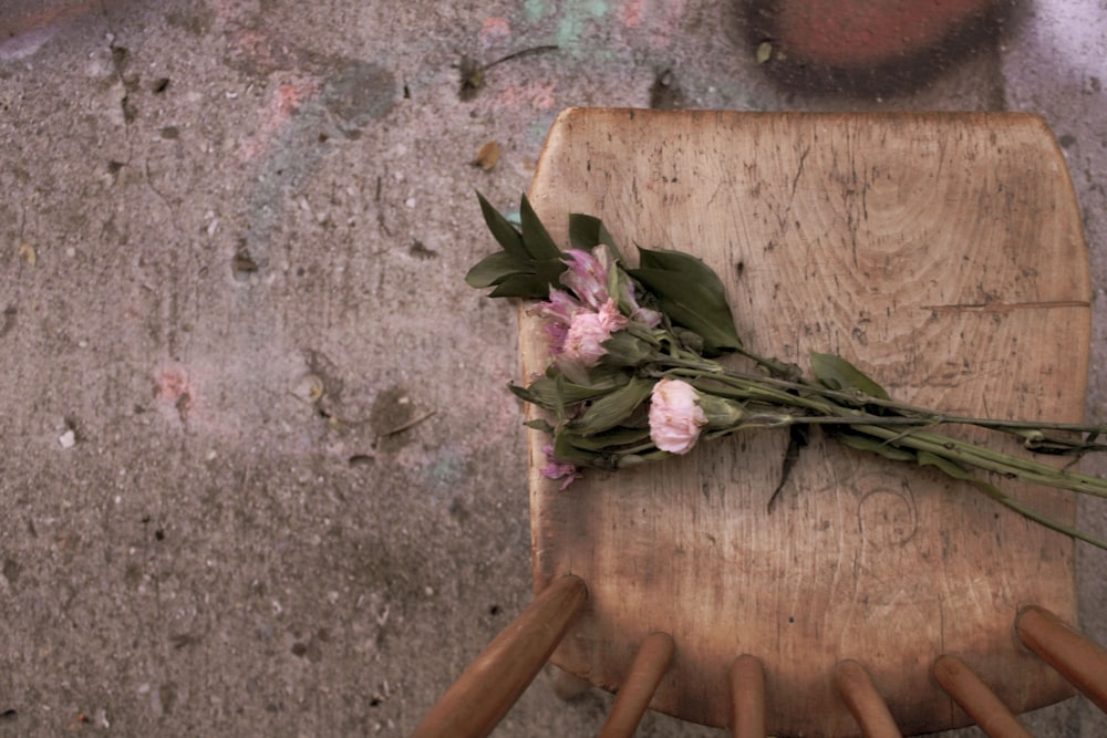 a bunch of flowers sitting on top of a wooden chair