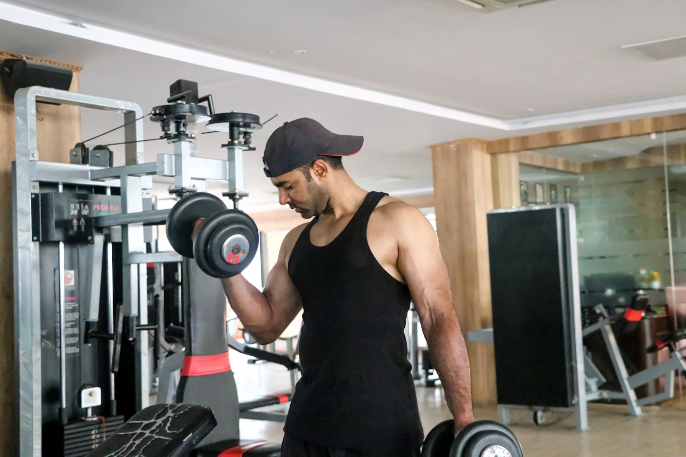 Athlete training with a dumbbell in a gym
