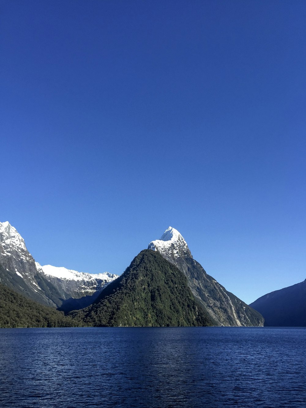 a large body of water with mountains in the background