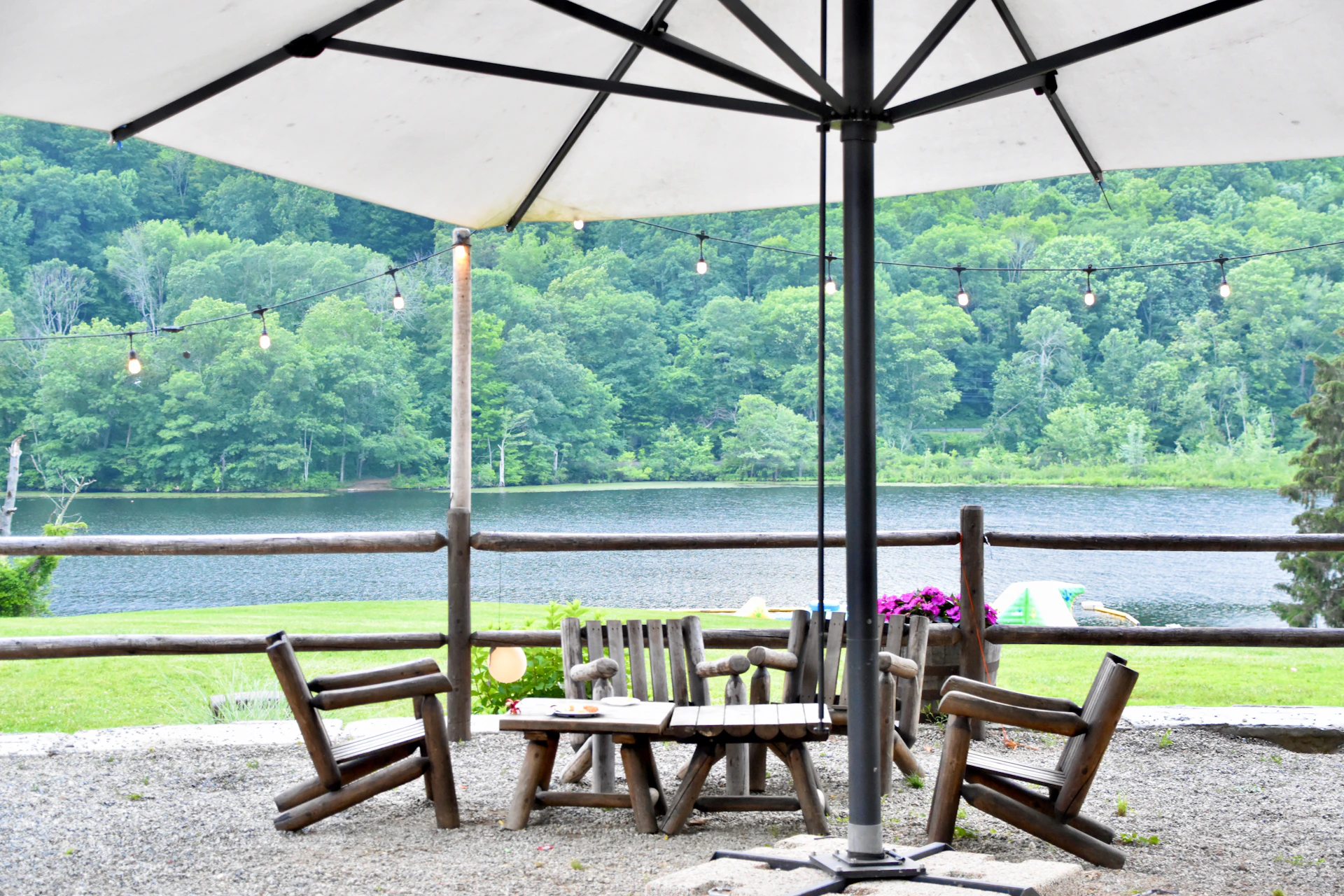 a patio with a table and chairs under an umbrella