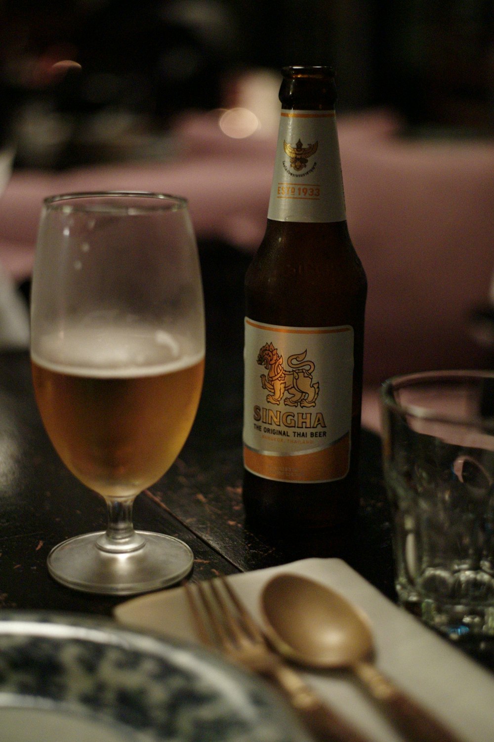 a bottle of beer and a glass on a table