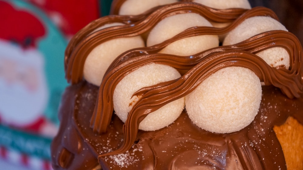 a close up of a cake with chocolate icing