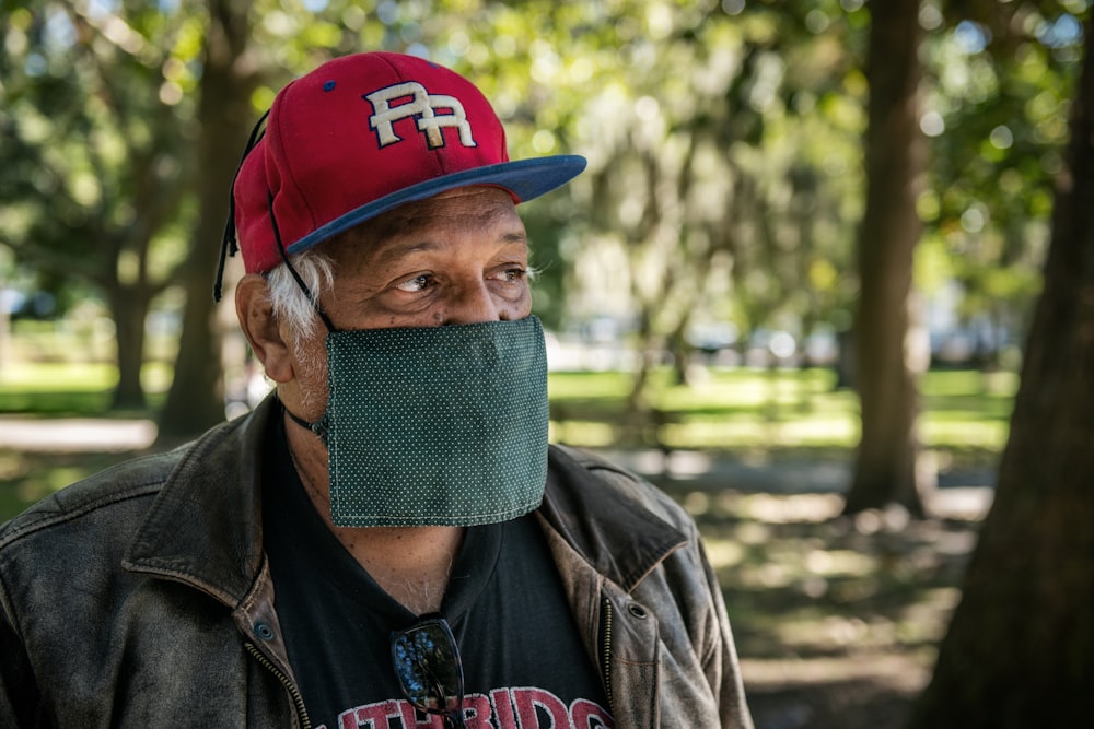 a man wearing a face mask in a park